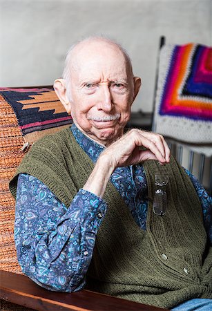 Stern elder gentleman sitting on chair in livingroom Photographie de stock - Aubaine LD & Abonnement, Code: 400-08254985