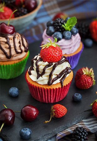 Set of different delicious cupcakes on dark Stock Photo - Budget Royalty-Free & Subscription, Code: 400-08255168