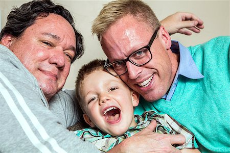 dad tickling son - Two gay men hug their happy young son Stock Photo - Budget Royalty-Free & Subscription, Code: 400-08255173