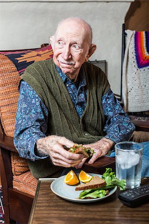 Elderly man holding a sandwich on a TV tray Stock Photo - Budget Royalty-Free & Subscription, Code: 400-08255195