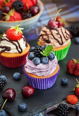 Set of different delicious cupcakes on dark Stock Photo - Budget Royalty-Free & Subscription, Code: 400-08255376