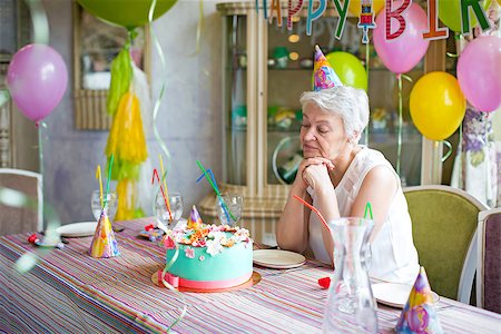 sad grandmother - Sad elderly woman at a birthday party Stock Photo - Budget Royalty-Free & Subscription, Code: 400-08255524