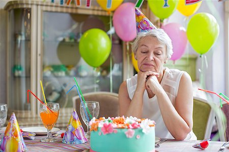 sad grandmother - Sad elderly woman at a birthday party Stock Photo - Budget Royalty-Free & Subscription, Code: 400-08255525
