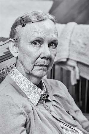 sad grandmother - Old woman seated and looking at camera Stock Photo - Budget Royalty-Free & Subscription, Code: 400-08255837