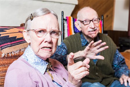 stern old woman - Angry old man and woman scowling at camera sitting in livingroom Stock Photo - Budget Royalty-Free & Subscription, Code: 400-08255856