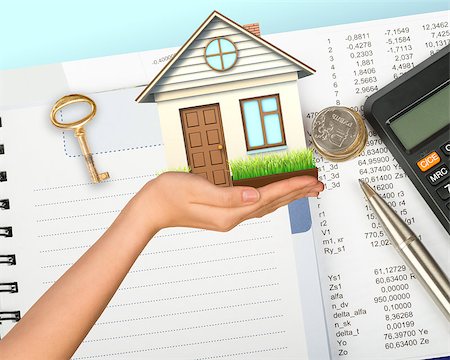 Humans hand holding house with key, pen and calculator Stock Photo - Budget Royalty-Free & Subscription, Code: 400-08255961