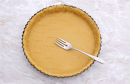 simsearch:400-07677933,k - Halfway through pricking shortcrust pastry case with a metal fork Stock Photo - Budget Royalty-Free & Subscription, Code: 400-08256606