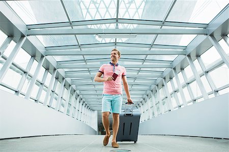 Young man with a suitcase at the airport Stock Photo - Budget Royalty-Free & Subscription, Code: 400-08256644