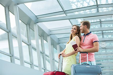 Young couple with a suitcase at the airport Stock Photo - Budget Royalty-Free & Subscription, Code: 400-08256643