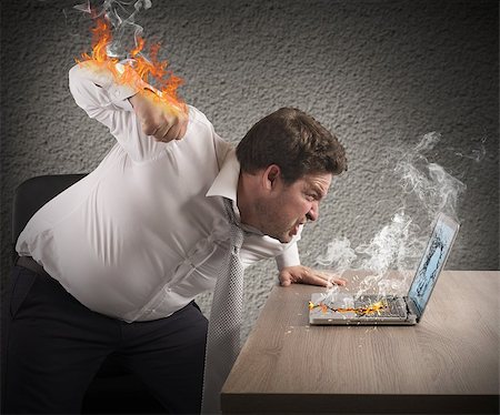simsearch:400-09030070,k - Angry man gives fiery fist to computer Stock Photo - Budget Royalty-Free & Subscription, Code: 400-08257126