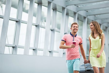 Smiling couple with a suitcase at the airport Stock Photo - Budget Royalty-Free & Subscription, Code: 400-08257437