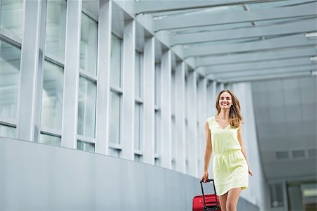Smiling girl with a suitcase at the airport Stock Photo - Budget Royalty-Free & Subscription, Code: 400-08257438