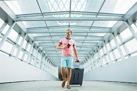 Young man with a suitcase at the airport Stock Photo - Budget Royalty-Free & Subscription, Code: 400-08257440