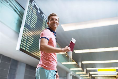 Young man with a passport at the board Stock Photo - Budget Royalty-Free & Subscription, Code: 400-08257456