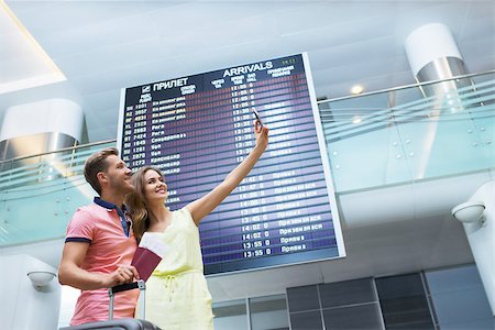 Smiling couple making selfie at the airport Stock Photo - Budget Royalty-Free & Subscription, Code: 400-08257462