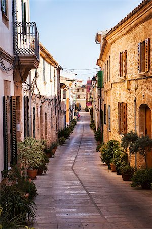 Narrow street old traditional houses village with flowers, Alcudia, Majorca island, Spain Stock Photo - Budget Royalty-Free & Subscription, Code: 400-08257597
