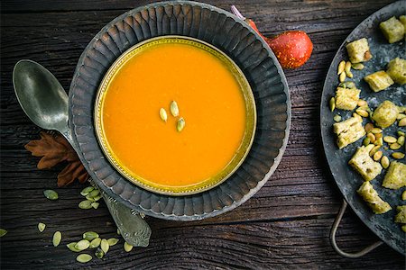 simsearch:400-06429990,k - Vegetarian food concept. Pumpkin soup with pumpkin seeds, croutons and garnish on wooden background Stock Photo - Budget Royalty-Free & Subscription, Code: 400-08257700