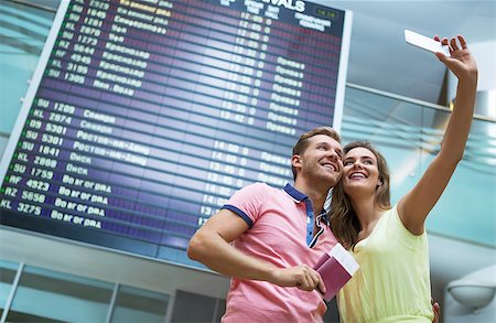 Young couple making selfie at the airport Stock Photo - Budget Royalty-Free & Subscription, Code: 400-08258971