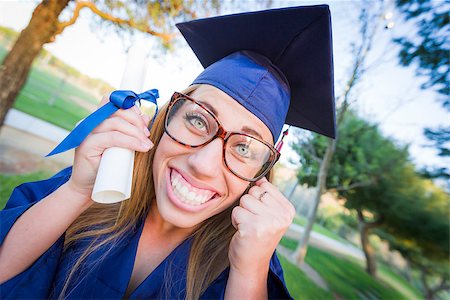 Excited and Expressive Young Woman Holding Diploma in Cap and Gown Outdoors. Stock Photo - Budget Royalty-Free & Subscription, Code: 400-08250444