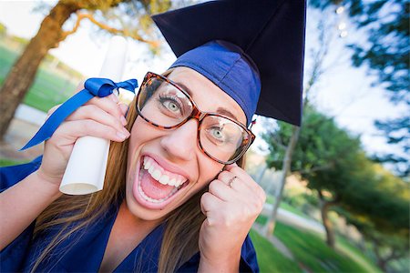 Excited and Expressive Young Woman Holding Diploma in Cap and Gown Outdoors. Stock Photo - Budget Royalty-Free & Subscription, Code: 400-08250445