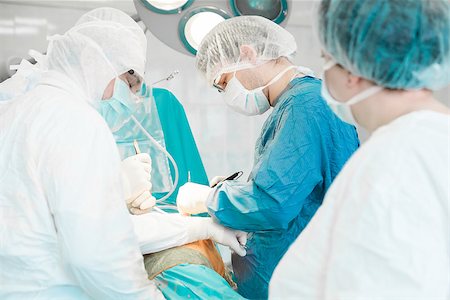 some surgeons  doing difficult operation in hospital Stock Photo - Budget Royalty-Free & Subscription, Code: 400-08250543