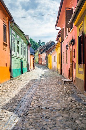 sighisoara - Sighisoara, Romania - June 23, 2013: Stone paved old streets with colored houses from Sighisoara fortresss, Transylvania, Romania Photographie de stock - Aubaine LD & Abonnement, Code: 400-08250632