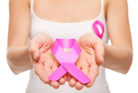 simsearch:400-07745360,k - Woman holding a pink cancer awareness ribbon in her hands Photographie de stock - Aubaine LD & Abonnement, Code: 400-08250701