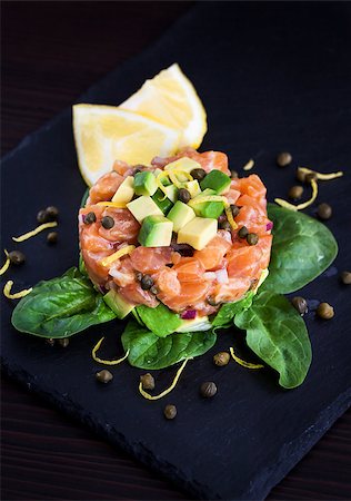 pickled lemon - Tasty salmon and avocado tartar, dark background Stock Photo - Budget Royalty-Free & Subscription, Code: 400-08251017