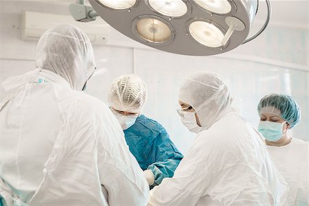 some surgeons  doing difficult operation in hospital Stock Photo - Budget Royalty-Free & Subscription, Code: 400-08251042