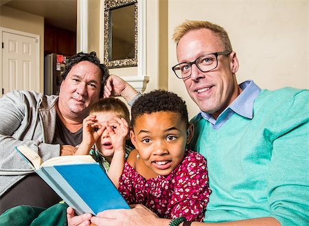 Attractive gay couple reads a book to their children Stock Photo - Budget Royalty-Free & Subscription, Code: 400-08251340