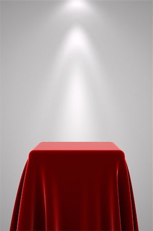 simsearch:400-07248992,k - Presentation pedestal covered with a red silk cloth in front of a white wall illuminated by a spot light Photographie de stock - Aubaine LD & Abonnement, Code: 400-08251394