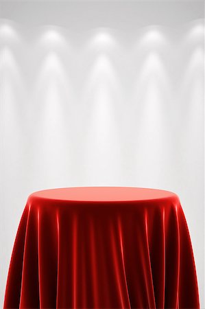 Round presentation pedestal covered with a red silk cloth in front of a white wall illuminated by a spot light Stockbilder - Microstock & Abonnement, Bildnummer: 400-08251397