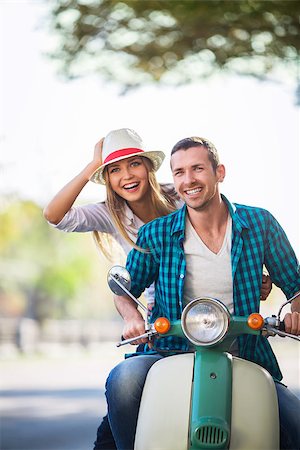 driving scooter women - Smiling couple on a scooter outdoors Stock Photo - Budget Royalty-Free & Subscription, Code: 400-08251417