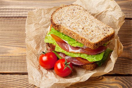 simsearch:400-07099478,k - Sandwich with salad, ham, cheese and tomatoes on wooden table Stock Photo - Budget Royalty-Free & Subscription, Code: 400-08251548