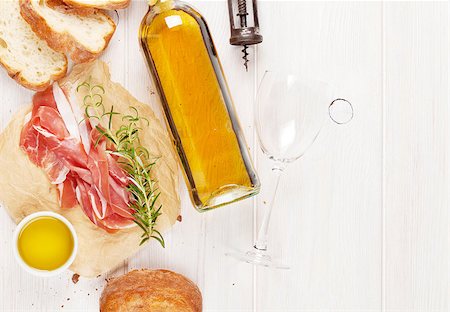 smoked ham - Prosciutto, wine, ciabatta, parmesan and olive oil on wooden table. Top view with copy space Foto de stock - Super Valor sin royalties y Suscripción, Código: 400-08251581