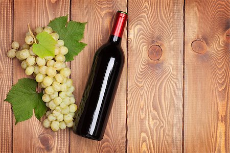 simsearch:400-08110621,k - Red wine bottle and bunch of white grapes on wooden table background with copy space Stock Photo - Budget Royalty-Free & Subscription, Code: 400-08251604