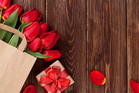 simsearch:400-08036453,k - Red tulips bouquet in paper bag and gift box over wooden table background with copy space Stock Photo - Budget Royalty-Free & Subscription, Code: 400-08251601