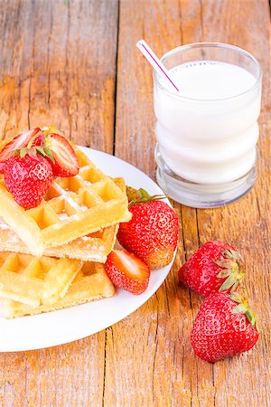 homemade waffles with strawberries maple syrup and glass with milk on wooden background Foto de stock - Super Valor sin royalties y Suscripción, Código: 400-08251877