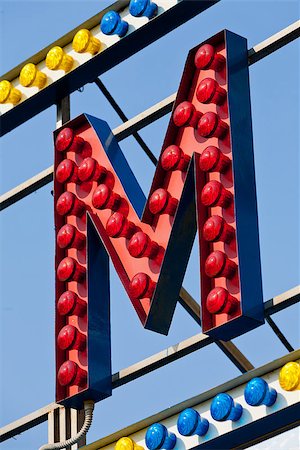 classic electric sign like the ones used in circus or old fashioned shops representing the M letter Foto de stock - Super Valor sin royalties y Suscripción, Código: 400-08252375