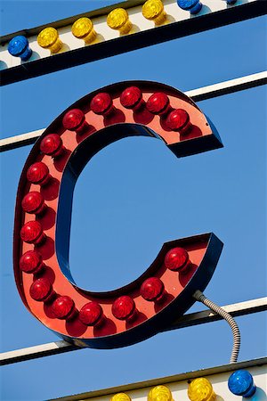 classic electric sign like the ones used in circus or old fashioned shops representing the C letter Foto de stock - Super Valor sin royalties y Suscripción, Código: 400-08252376