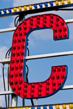 classic electric sign like the ones used in circus or old fashioned shops representing the C letter Foto de stock - Super Valor sin royalties y Suscripción, Código: 400-08252384