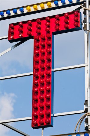 classic electric sign like the ones used in circus or old fashioned shops representing the T letter Foto de stock - Super Valor sin royalties y Suscripción, Código: 400-08252386