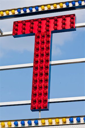 classic electric sign like the ones used in circus or old fashioned shops representing the T letter Foto de stock - Super Valor sin royalties y Suscripción, Código: 400-08252381