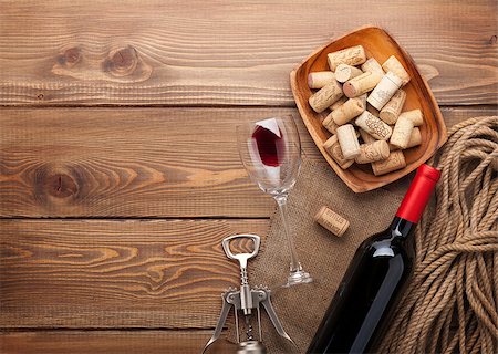 stopper - Red wine bottle, wine glass, bowl with corks and corkscrew. View from above over rustic wooden table background Stock Photo - Budget Royalty-Free & Subscription, Code: 400-08252604