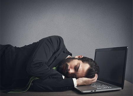 Businessman workload falls asleep tired on computer Stock Photo - Budget Royalty-Free & Subscription, Code: 400-08252713