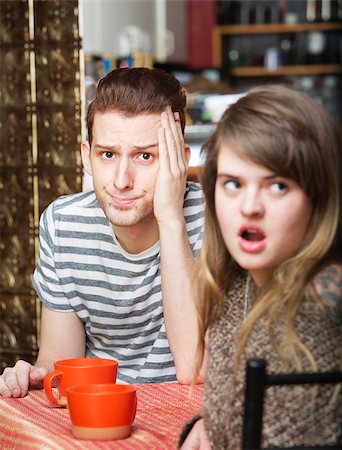 Frustrated young man sitting in cafe with woman Stock Photo - Budget Royalty-Free & Subscription, Code: 400-08252897