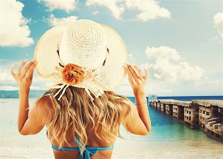 fashion accessories photos beach - Girl with straw hat sunbathing near jetty Stock Photo - Budget Royalty-Free & Subscription, Code: 400-08253021