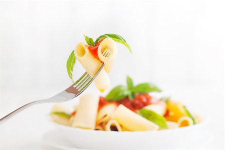 simsearch:400-04031652,k - Pasta with Tomato Sauce and Basil on a Fork. Italian food. Mediterranean cuisine Stock Photo - Budget Royalty-Free & Subscription, Code: 400-08253136