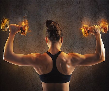 Gym woman train back with fiery dumbbells Stock Photo - Budget Royalty-Free & Subscription, Code: 400-08253261