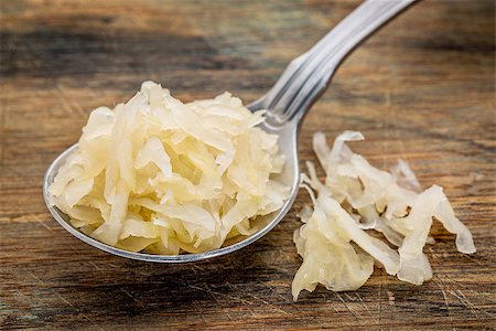 simsearch:400-08342479,k - tablespoon of sauerkraut against rustic wooden cutting board - healthy eating concept Stock Photo - Budget Royalty-Free & Subscription, Code: 400-08253311